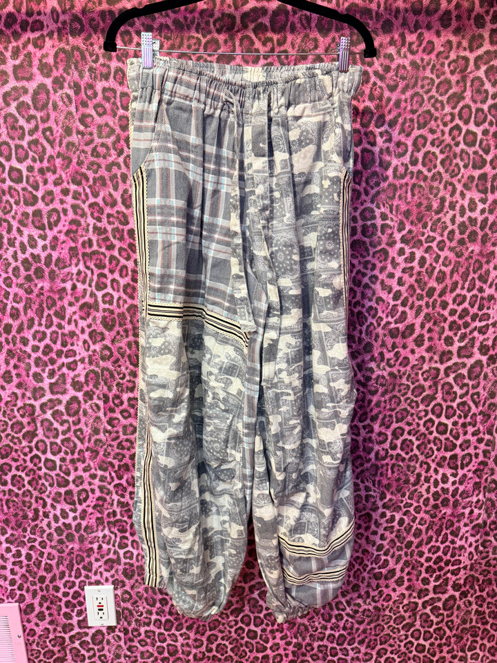 Gray pants with gold accents on a pink leopard print background