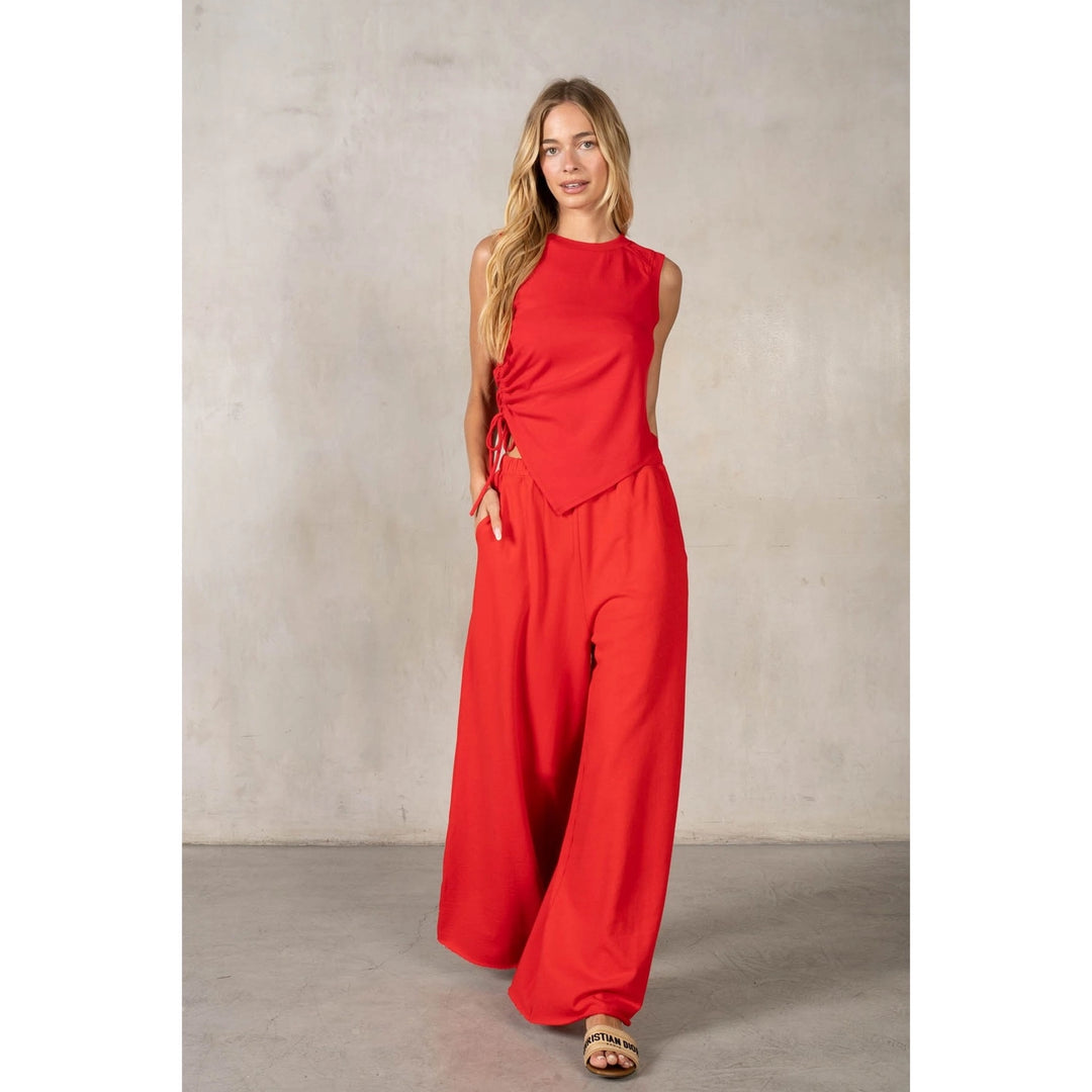 Woman wearing a red outfit against a plain background