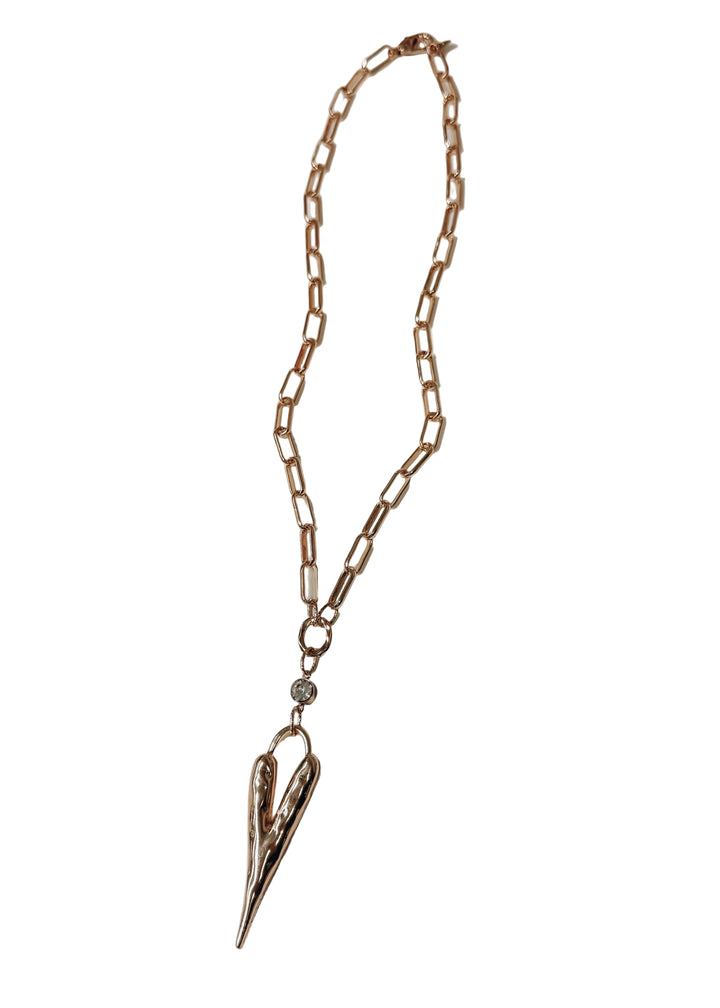 Gold heart necklace with crystal pendant on white background