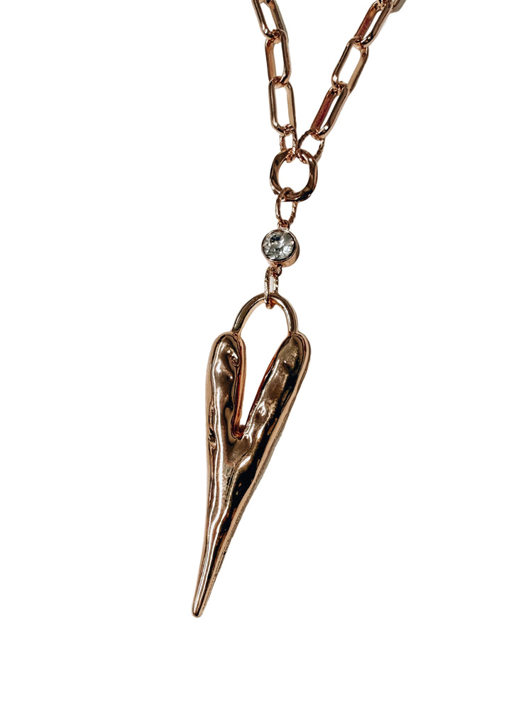 Gold chain necklace with heart pendant and crystal on white background