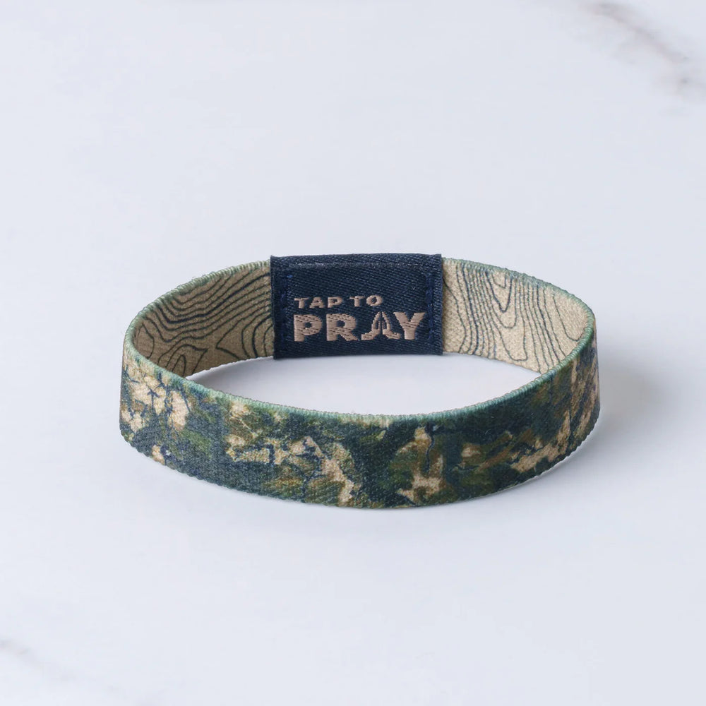 Wristband with 'Tap to Pray' tag on a white background