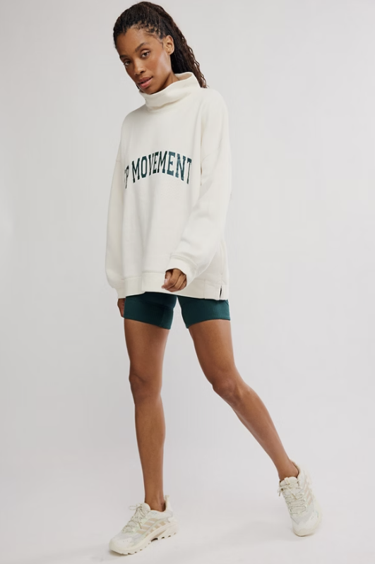 Woman wearing ivory top with &