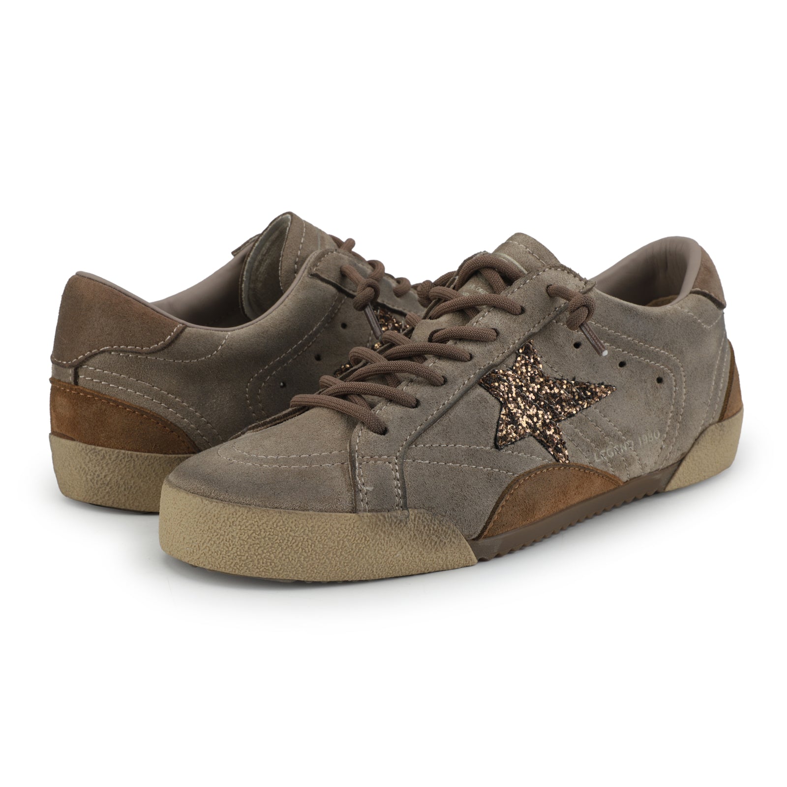 Brown sneaker shoes with glitter gold star on white background