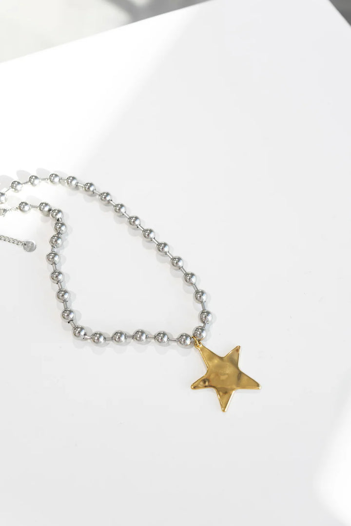 Necklace with a gold star pendant on a white background