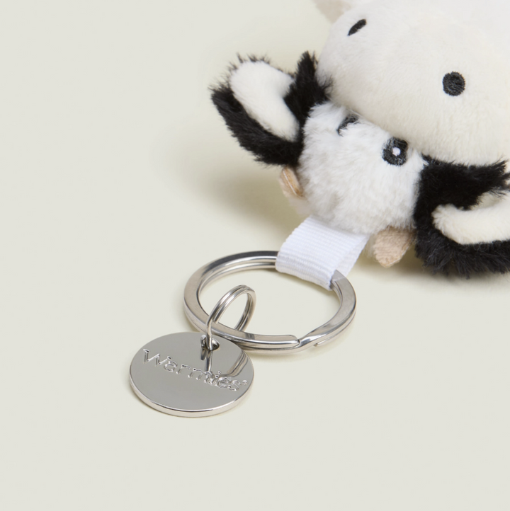 Plush keychain with a tag on a light background