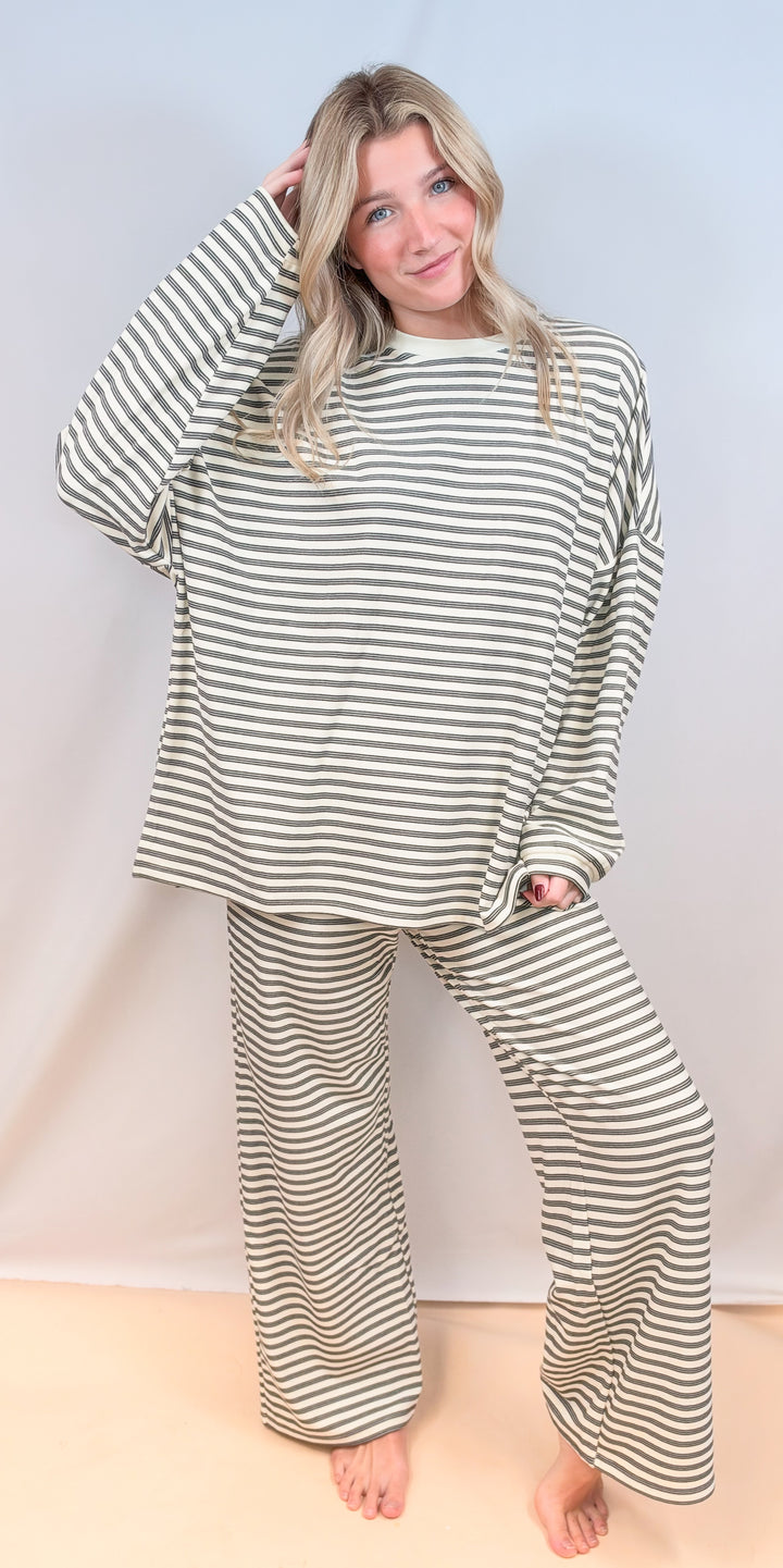 Woman wearing cream stripe matching set on plain background