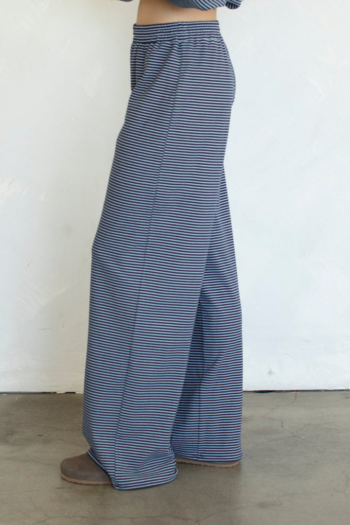 Blue and white striped wide-leg pants worn by a person on a plain background