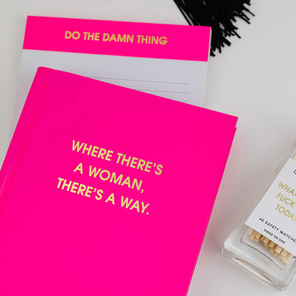 A bright pink hardcover book or journal with gold foil text reading &