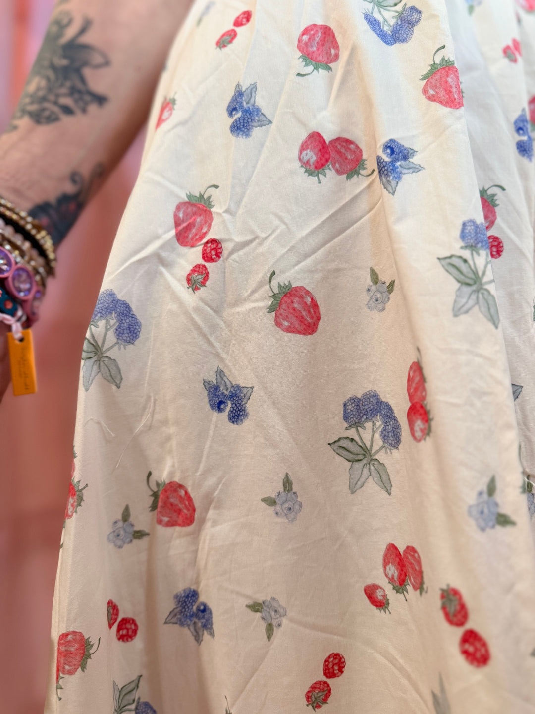 Close-up of a fabric with strawberry and butterfly pattern on a white background