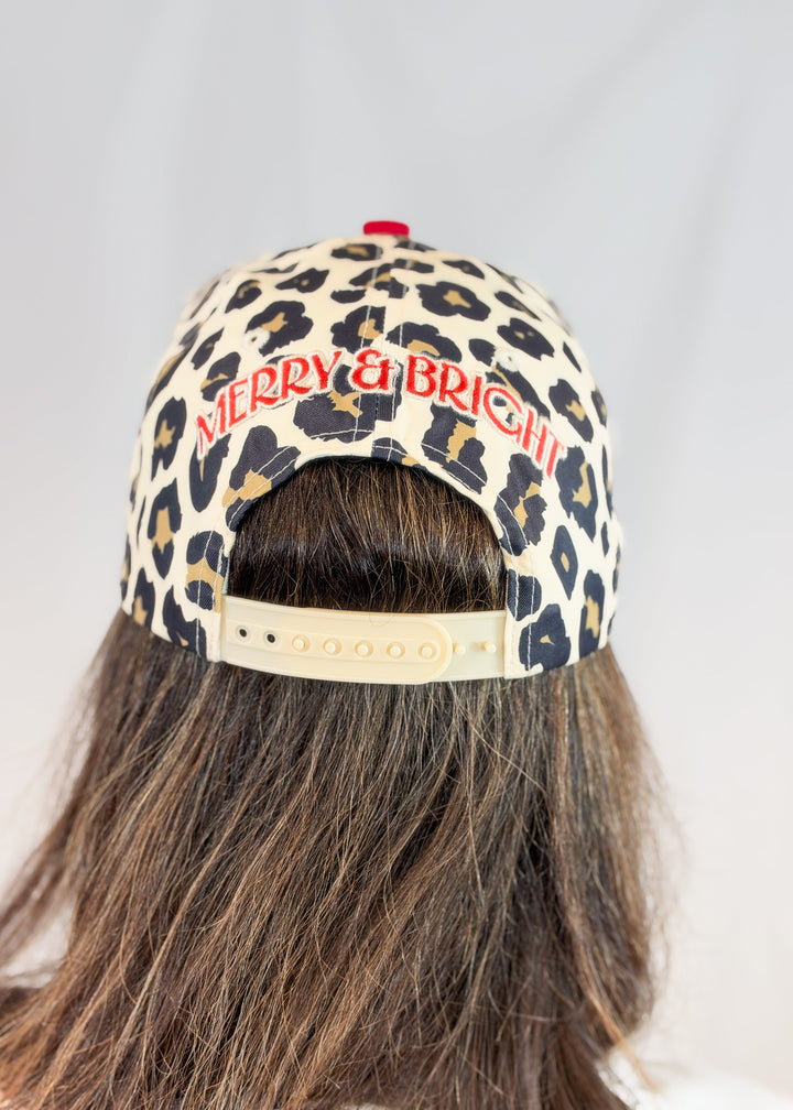Woman shown from back wearing leopard print trucker hat and &