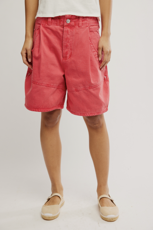 Person wearing red shorts on a plain background