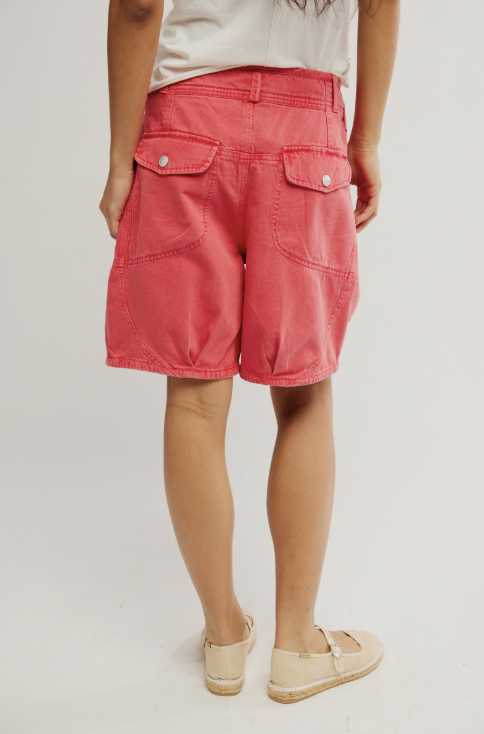 person wearing red shorts on plain background