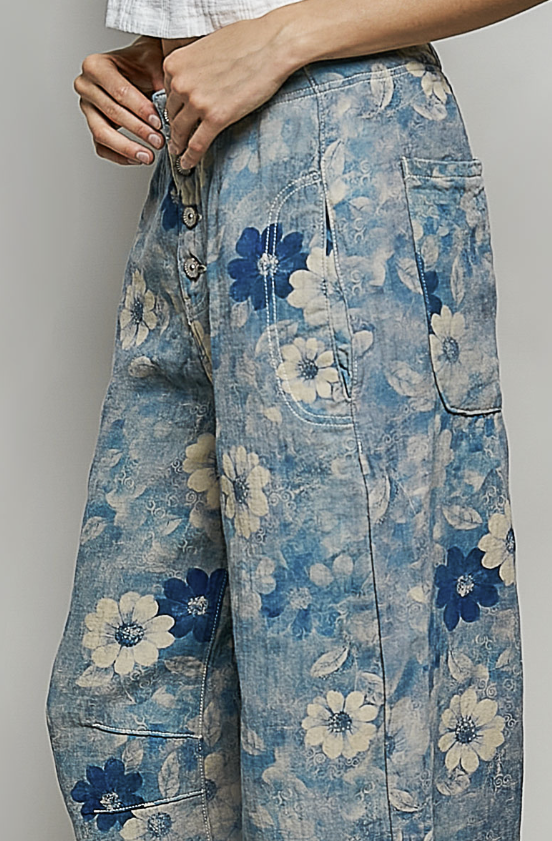 Blue floral-patterned pants being worn by a person.