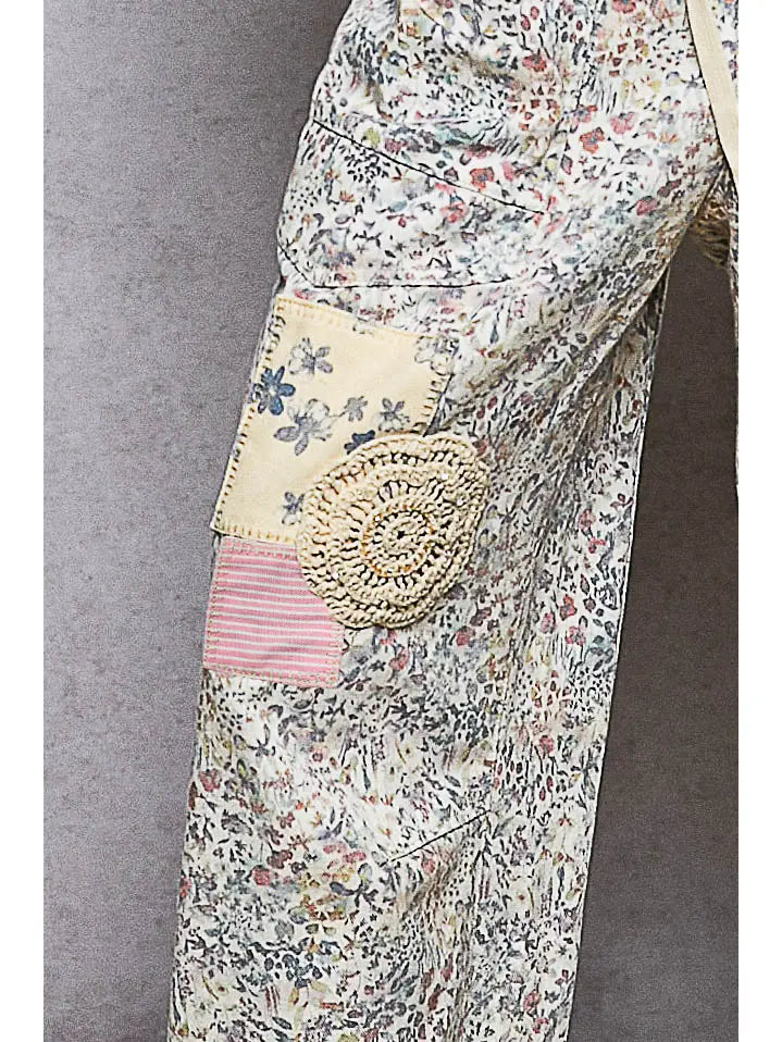 Floral patterned garment with a decorative patch on a gray background
