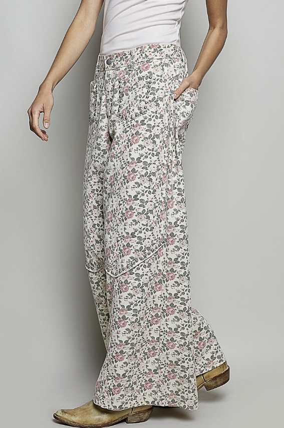 Floral patterned pants worn by a person on a plain background