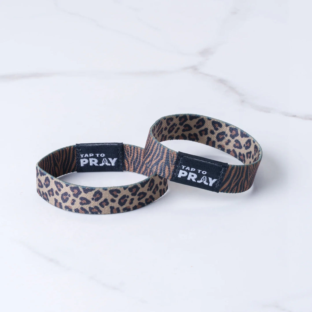 Two leopard print wristbands with &