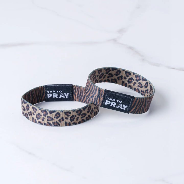 Two leopard print wristbands with &