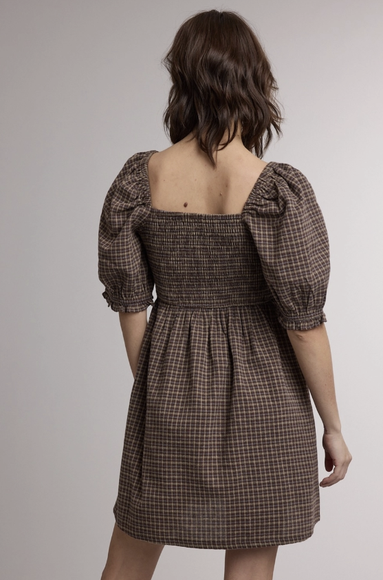 Woman shown from back wearing brown plaid puff sleeve mini dress on plain background