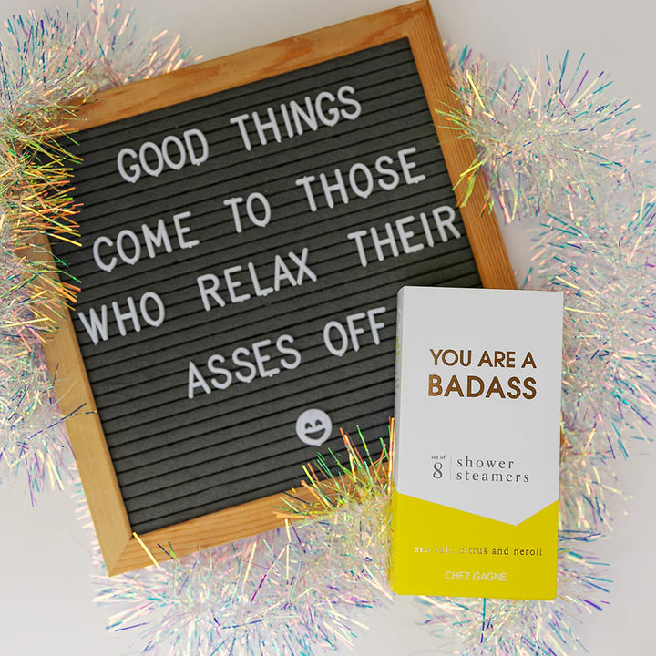 A letter board sign with a wooden frame reads &