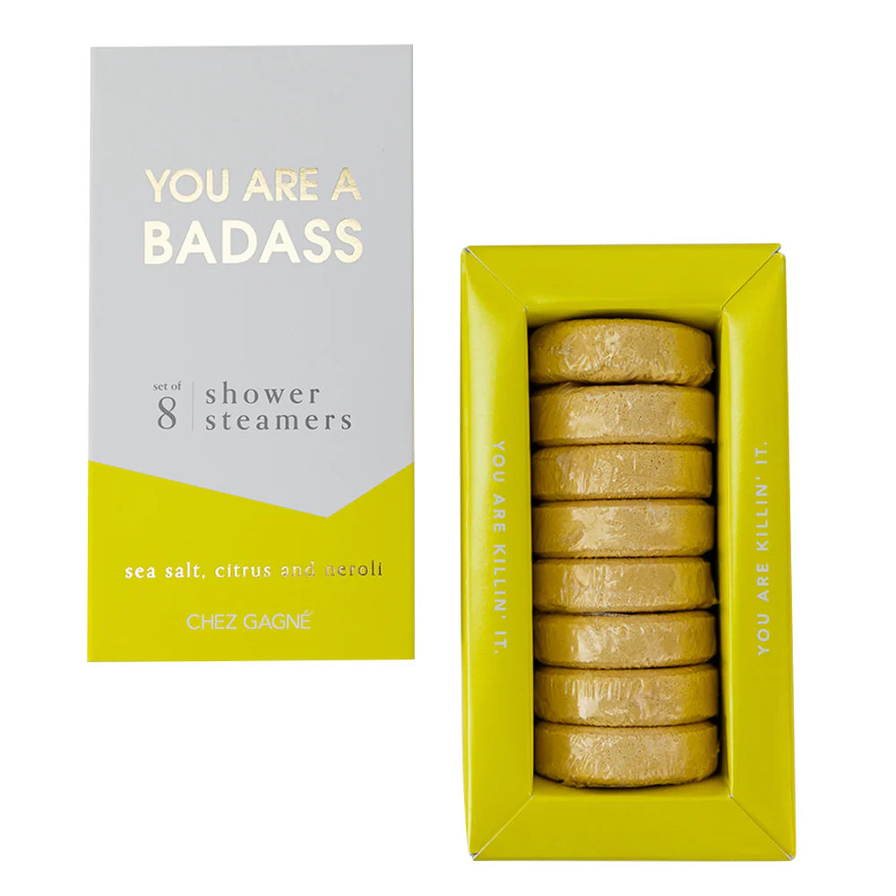 Chez Gagné shower steamers set in a bright yellow-green box next to its white and yellow packaging box, showing the wrapped round steamers inside.