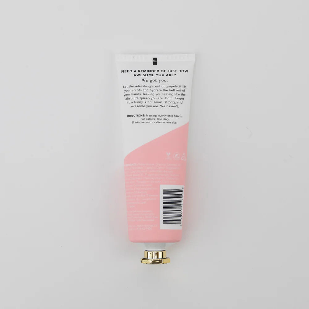 Pink hand cream with a white label on a light gray background