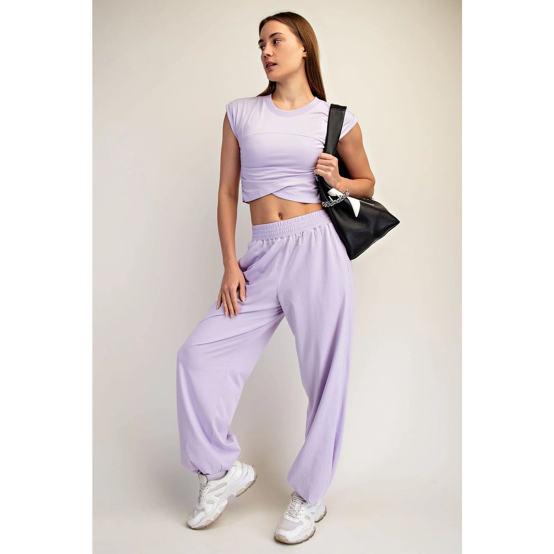 woman wearing purple matching set on plain background