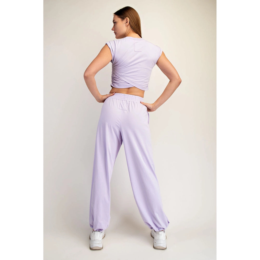 back of woman wearing purple matching set on plain background