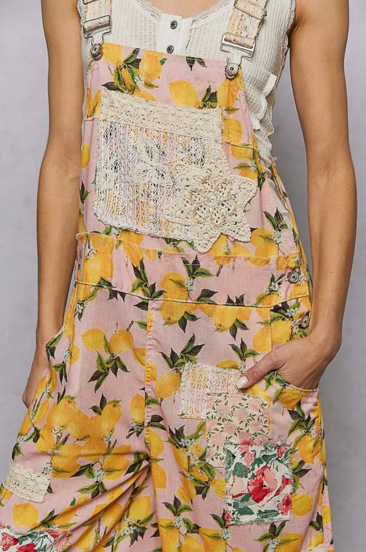 Vintage-style dress with floral and lemon pattern on a plain background