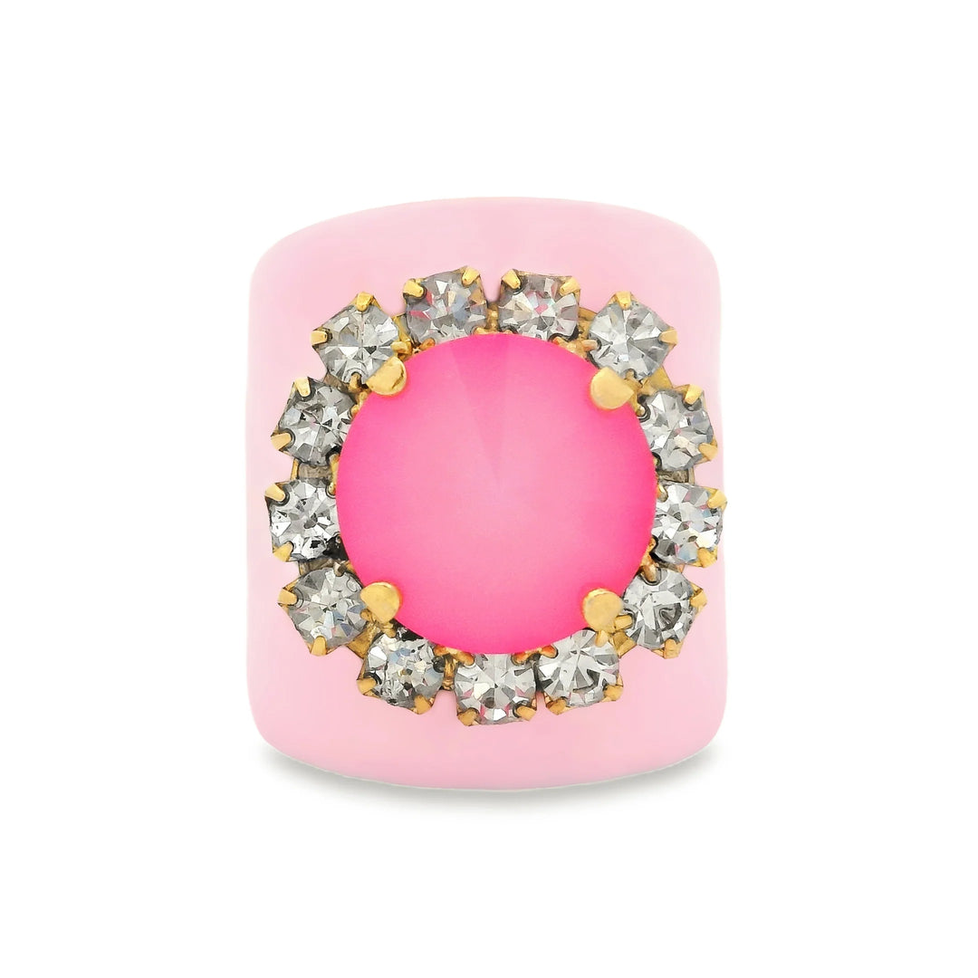 Pink enamel ring with large pink center crystal and surrounding clear crystals on white background