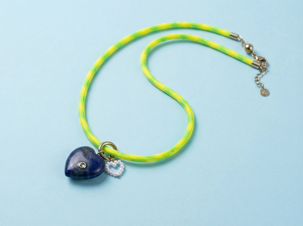 Necklace with a heart-shaped pendant on a light blue background