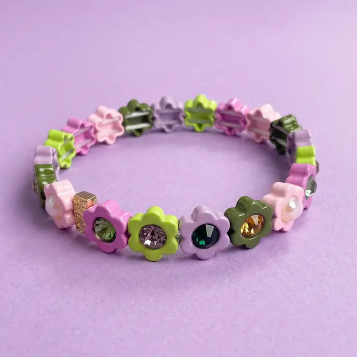 Colorful flower-shaped bracelet on a purple background