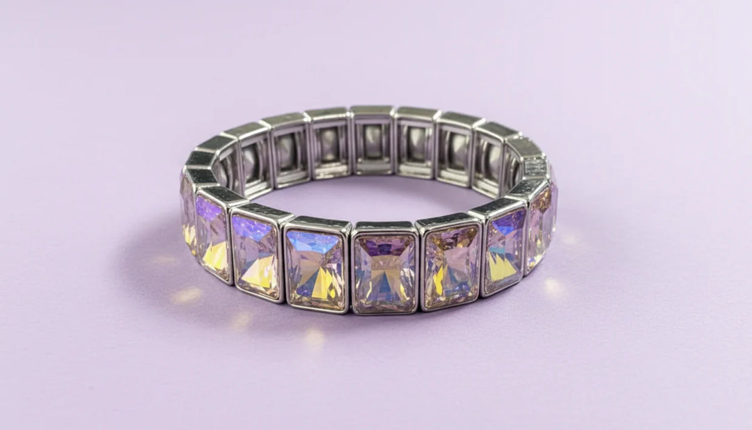 Silver bracelet with colorful gemstones on a light purple background