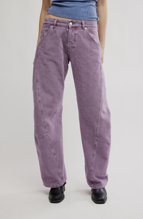 Woman wearing purple pants on white background