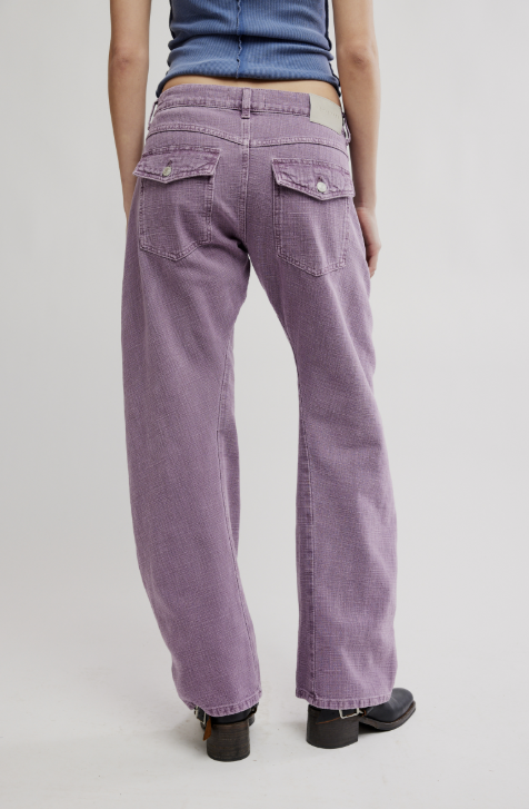 Woman wearing purple pants on white background
