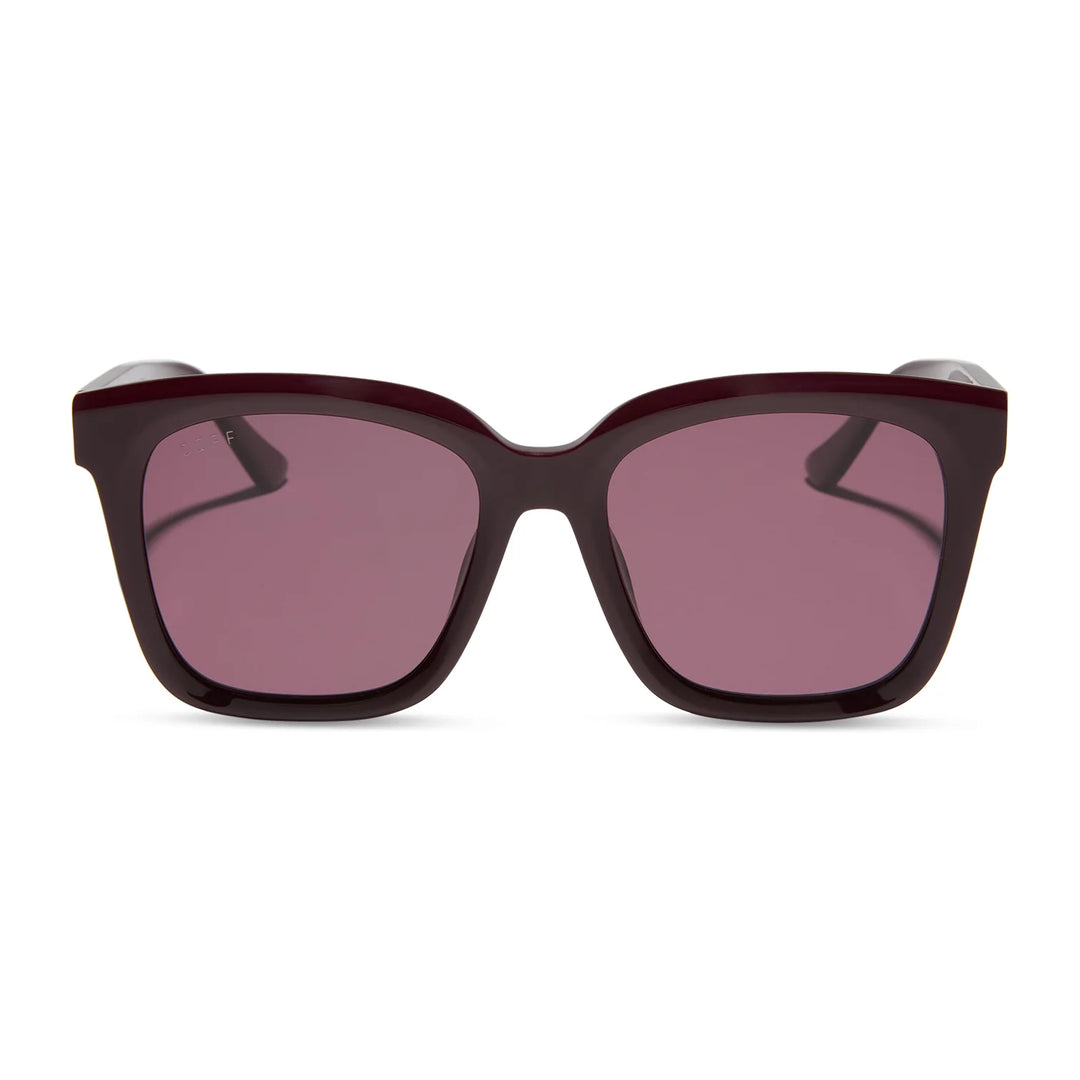 Sunglasses with dark brown frame and pink lenses on a white background