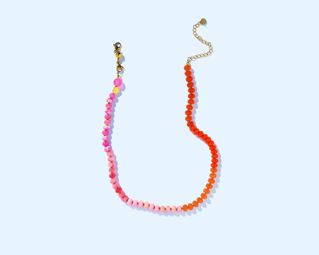 Necklace with pink and orange beads on a light blue background