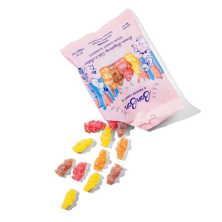Pink bag of gummy bears with colorful gummy bears spilling out on a white background