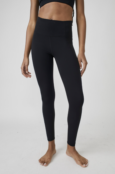 Person wearing black leggings on a white background