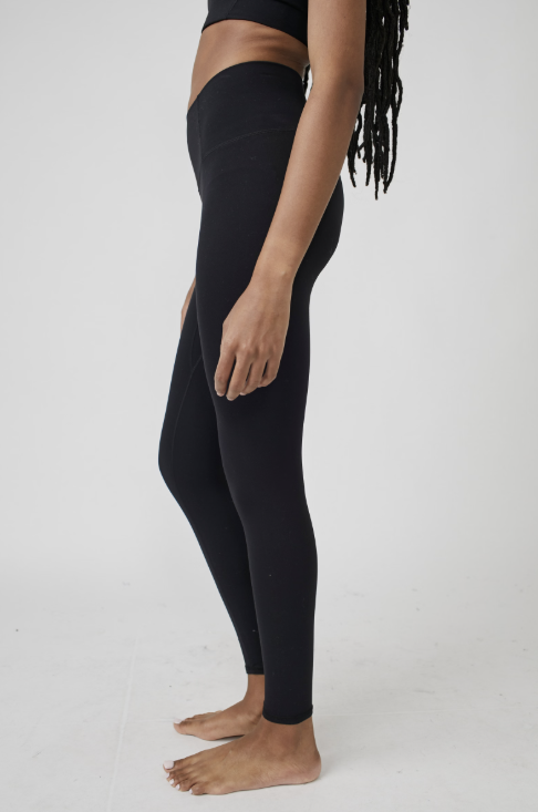 Person wearing black leggings on a white background