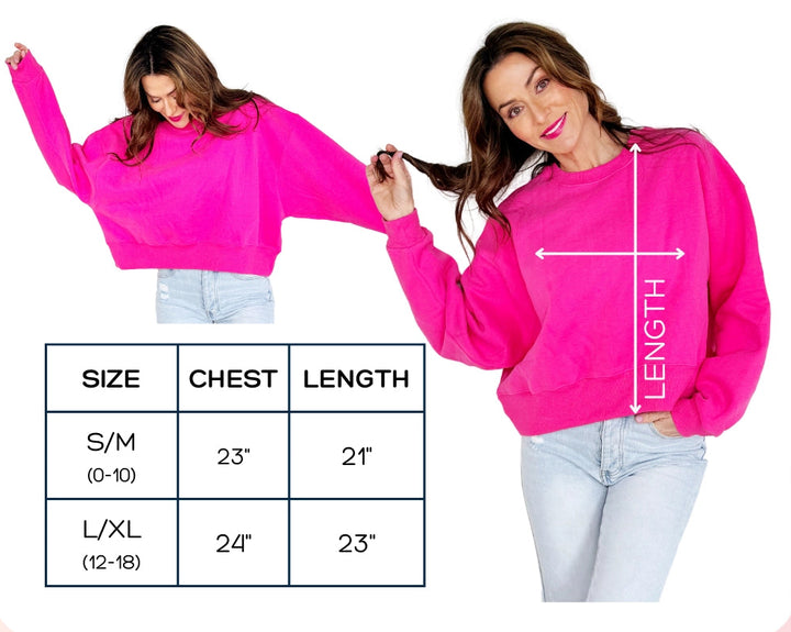 Pink crop sweatshirt with size chart and measurements on a pink background