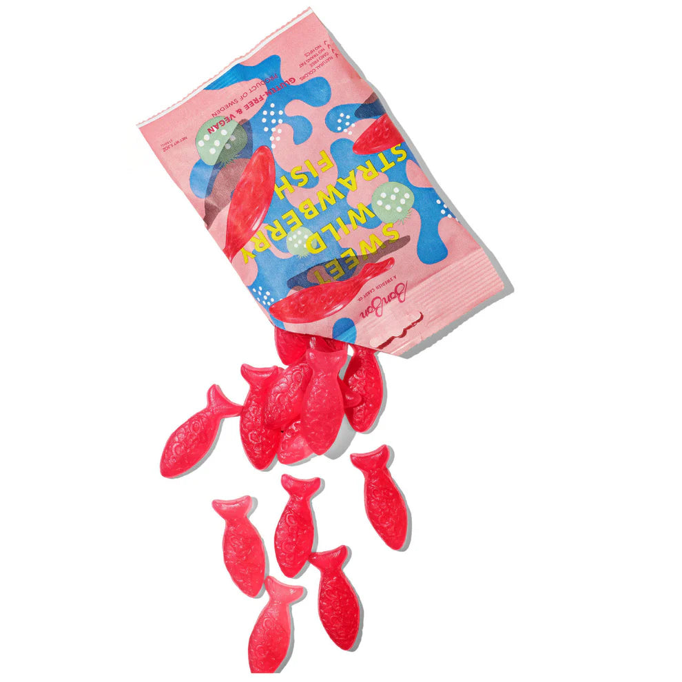Red fish-shaped gummy candies with a colorful packaging on a white background