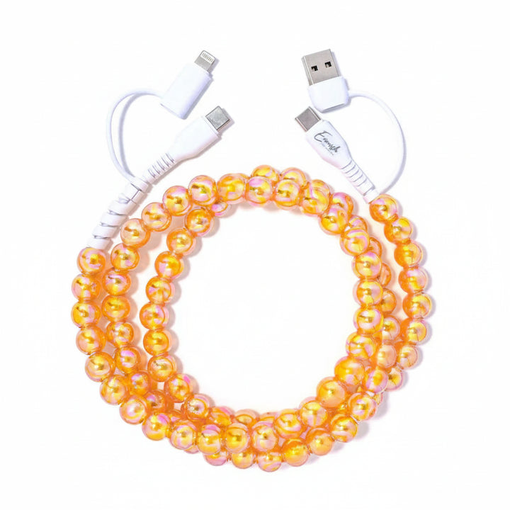 beaded orange phone charger on plain background