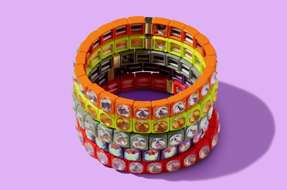 Stack of colorful bracelets with animal illustrations on a purple background