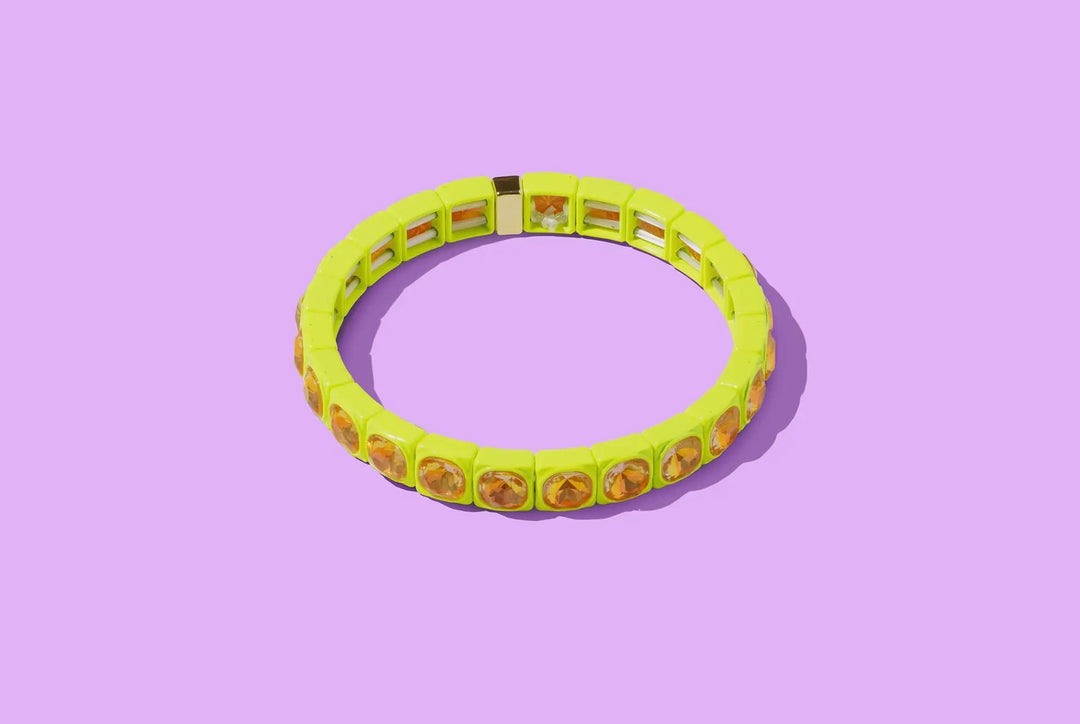 Yellow bracelet with avocado pattern on a purple background