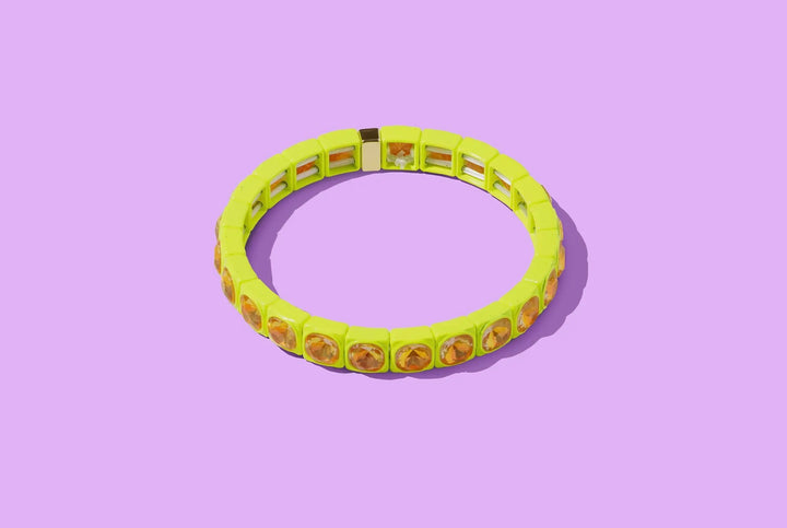 Yellow bracelet with avocado pattern on a purple background